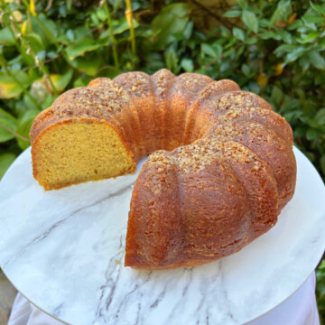 Banana Rum Cake, sliced, on a cake pedestal.