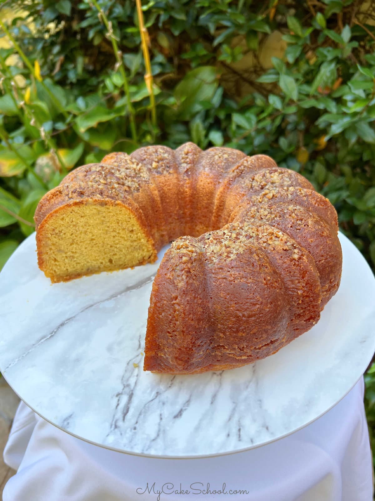 Banana Rum Cake, sliced, on a cake pedestal.