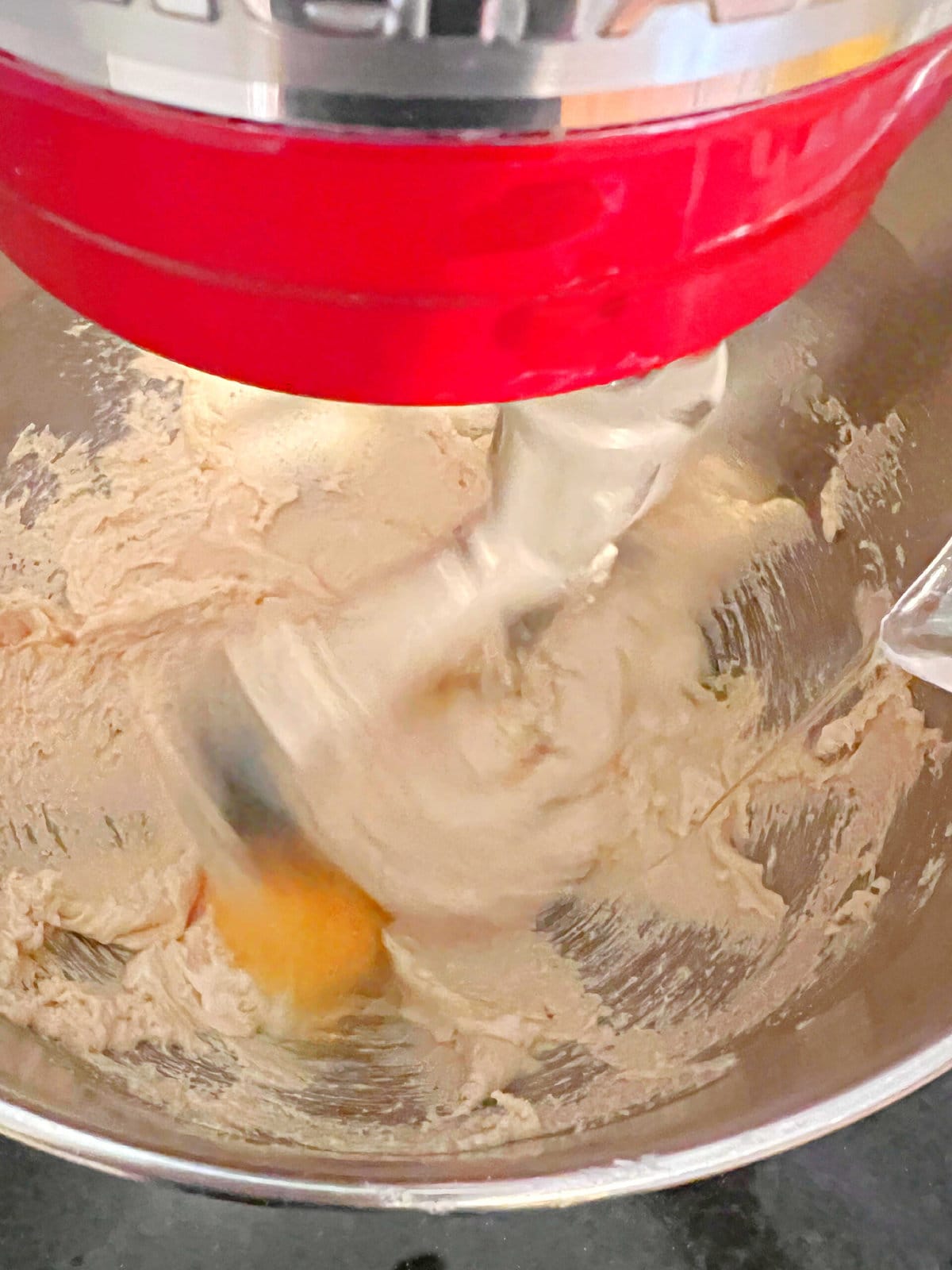 Adding eggs to the batter for Chocolate Chip Cupcakes.