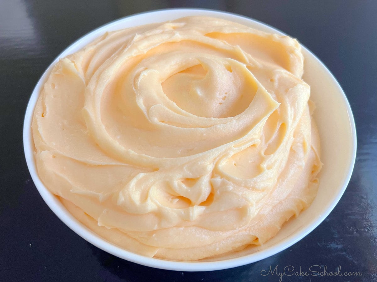 Bowl of Orange Cream Cheese Frosting.