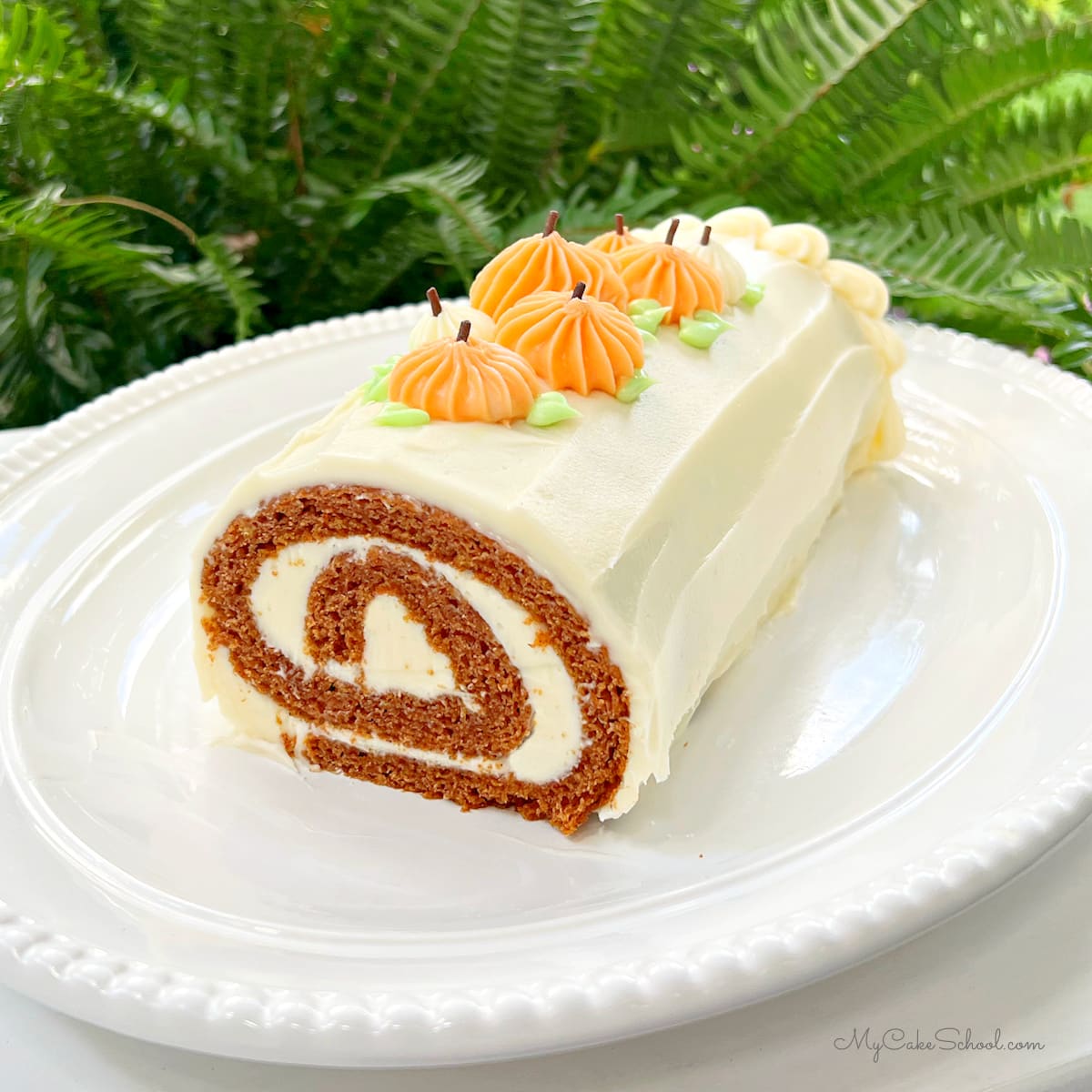 Pumpkin Roll Cake on platter.