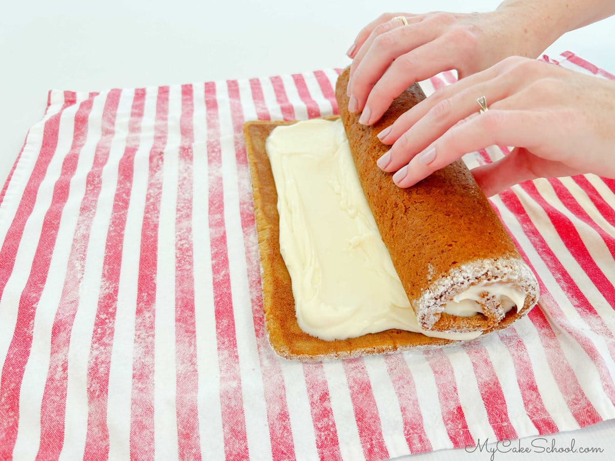 Rolling up the filled Pumpkin Roll Cake