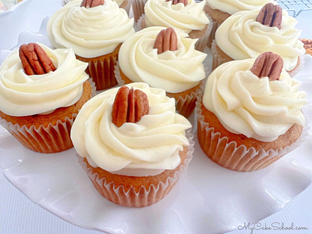 Sweet Potato Cupcakes, frosted and topped with pecans.