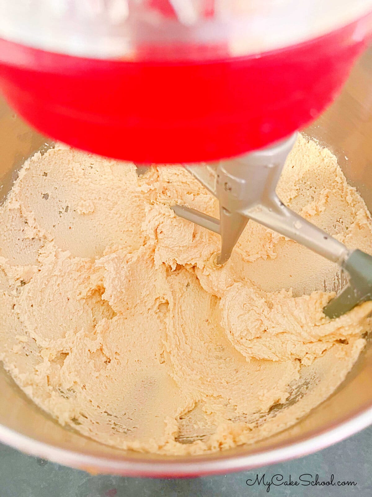 Mixture of sugar and butter in mixing bowl.