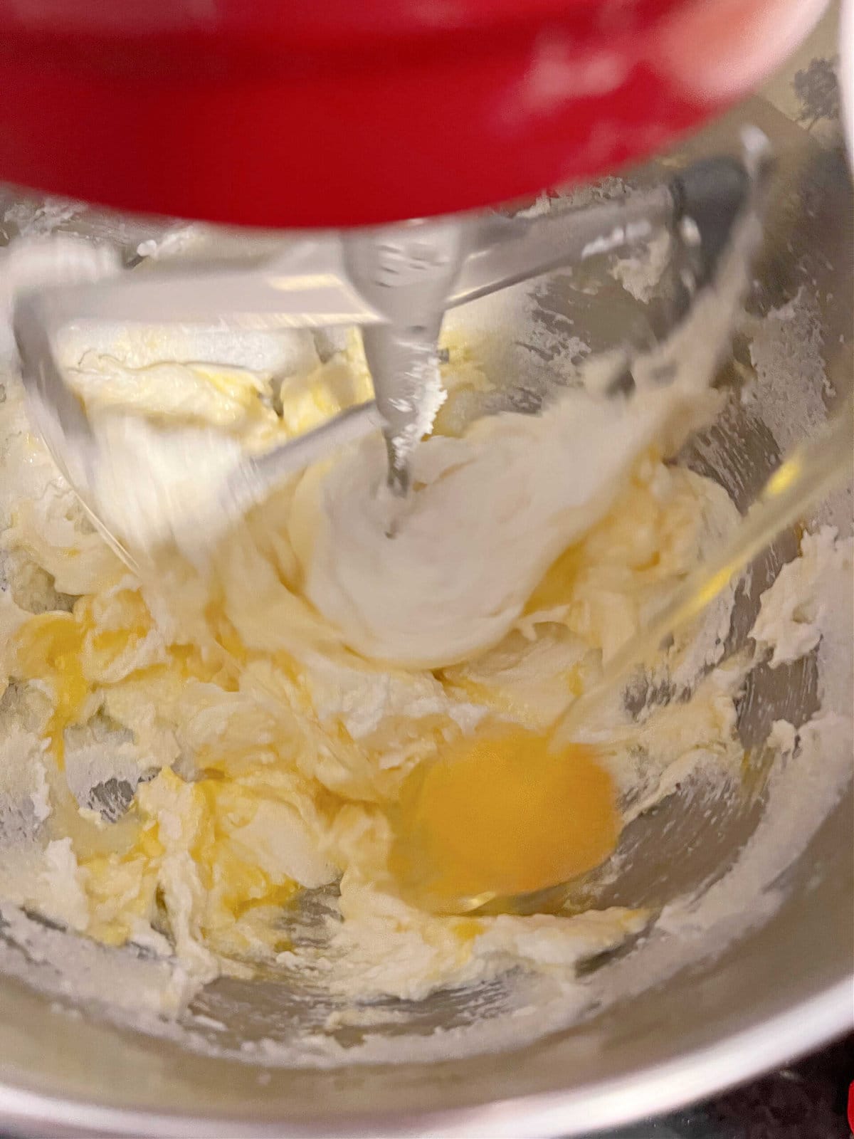 Adding eggs to the cake batter.