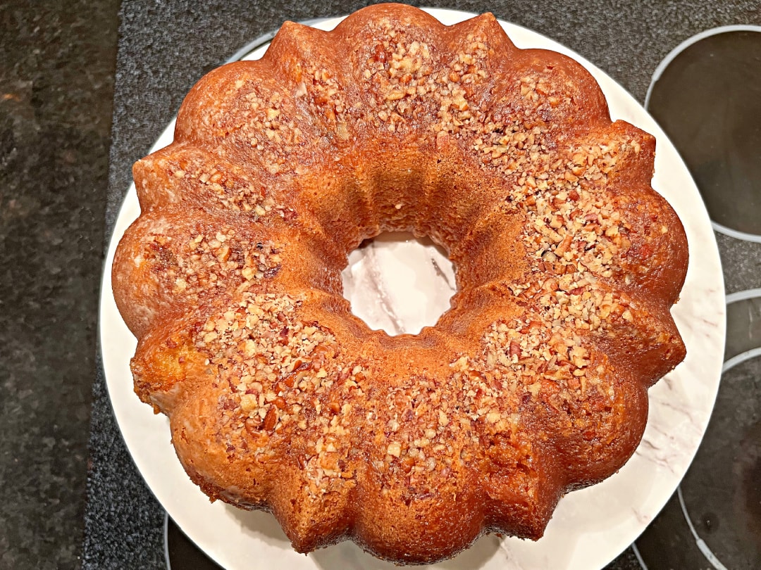 Freshly baked Banana Rum Cake on a cake pedestal.