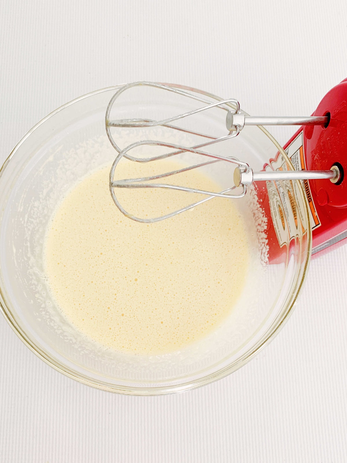 Mixing ingredients for Pumpkin Roll Cake.