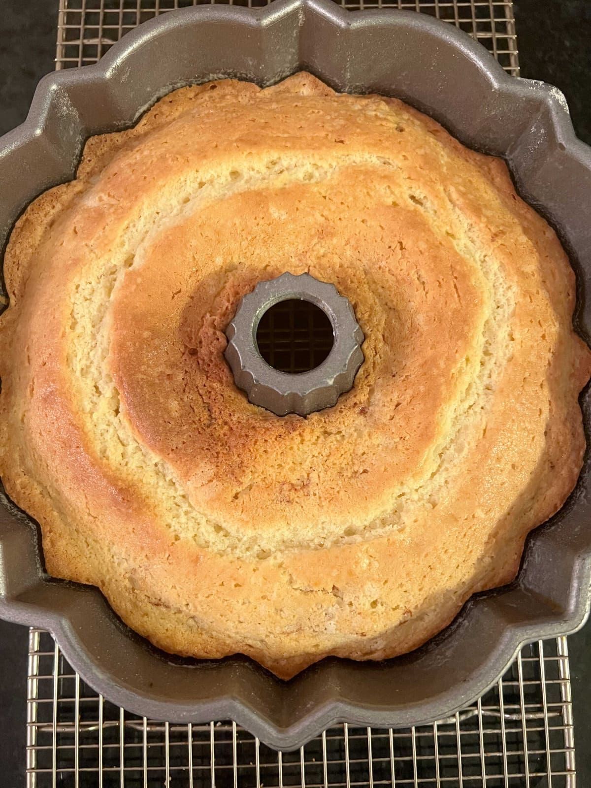 Freshly baked Snickerdoodle Cake on a cooling rack.