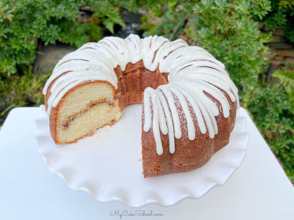 Sliced Snickerdoodle Bundt Cake on a pedestal.