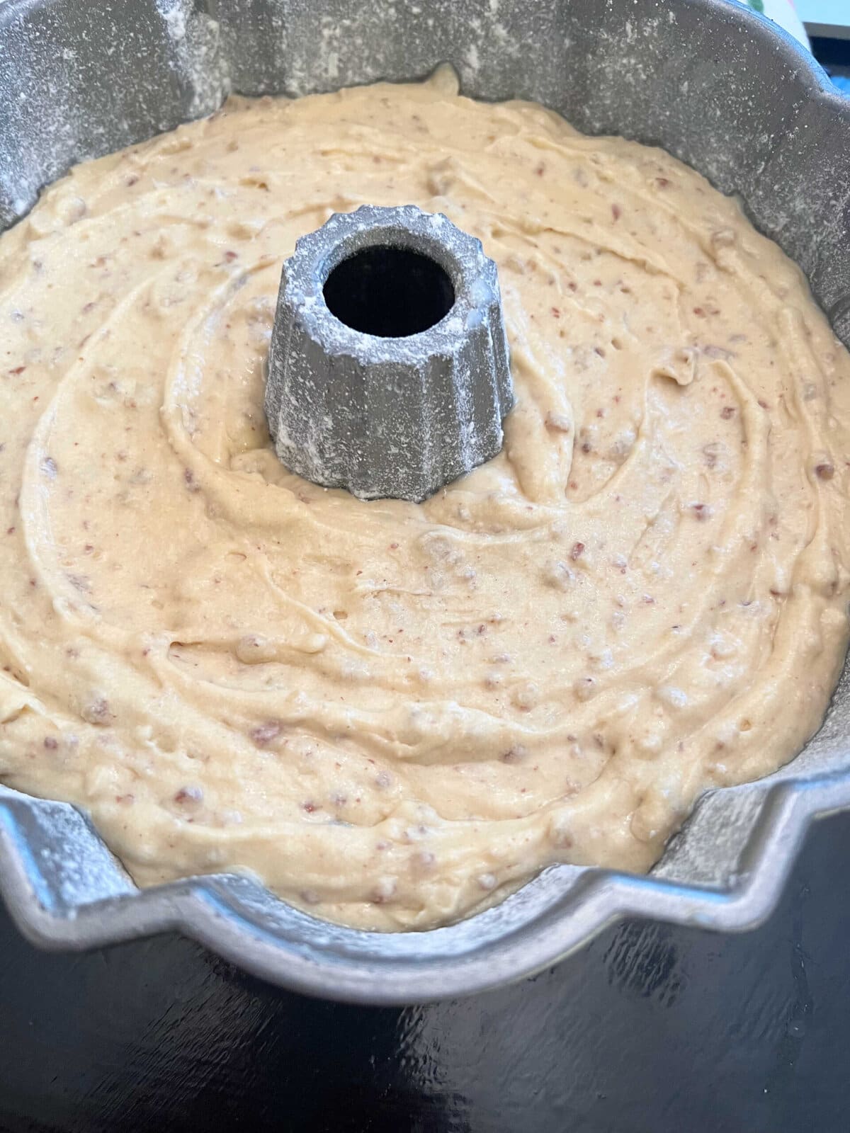 Bundt can filled with butter pecan cake batter.