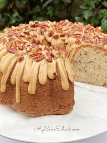 Butter pecan pound cake, sliced, on a cake pedestal.