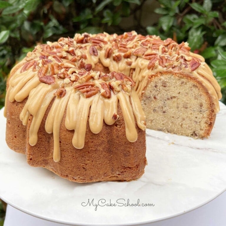 Butter pecan pound cake, sliced, on a cake pedestal.