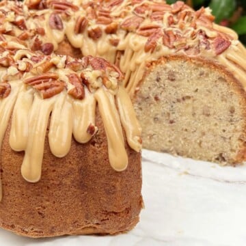 Butter Pecan Cake, sliced, on pedestal.