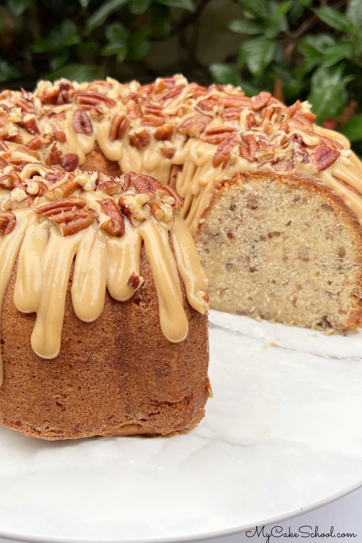 Butter Pecan Cake, sliced, on pedestal.