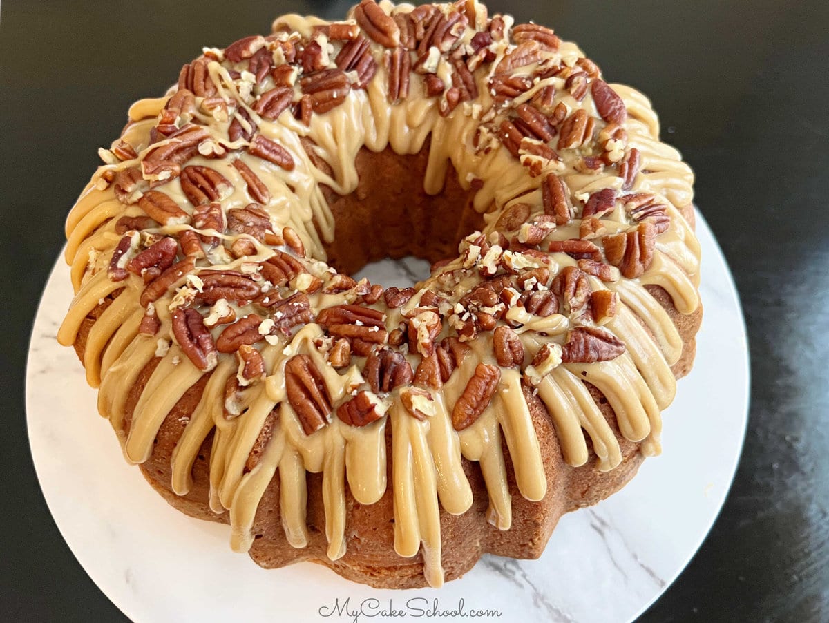 Butter Pecan Pound Cake topped with caramel glaze and buttered pecans.