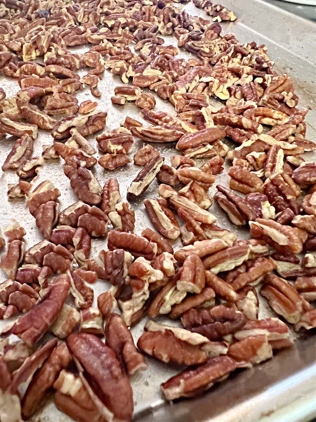 Buttered pecans on cookie sheet.