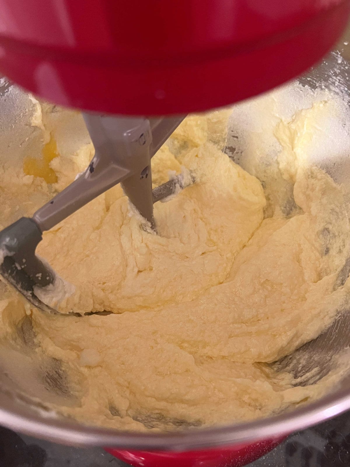 Adding eggs to the butter and sugar mixture.