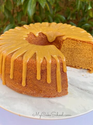 Gingerbread bundt cake, sliced, on a cake pedestal.