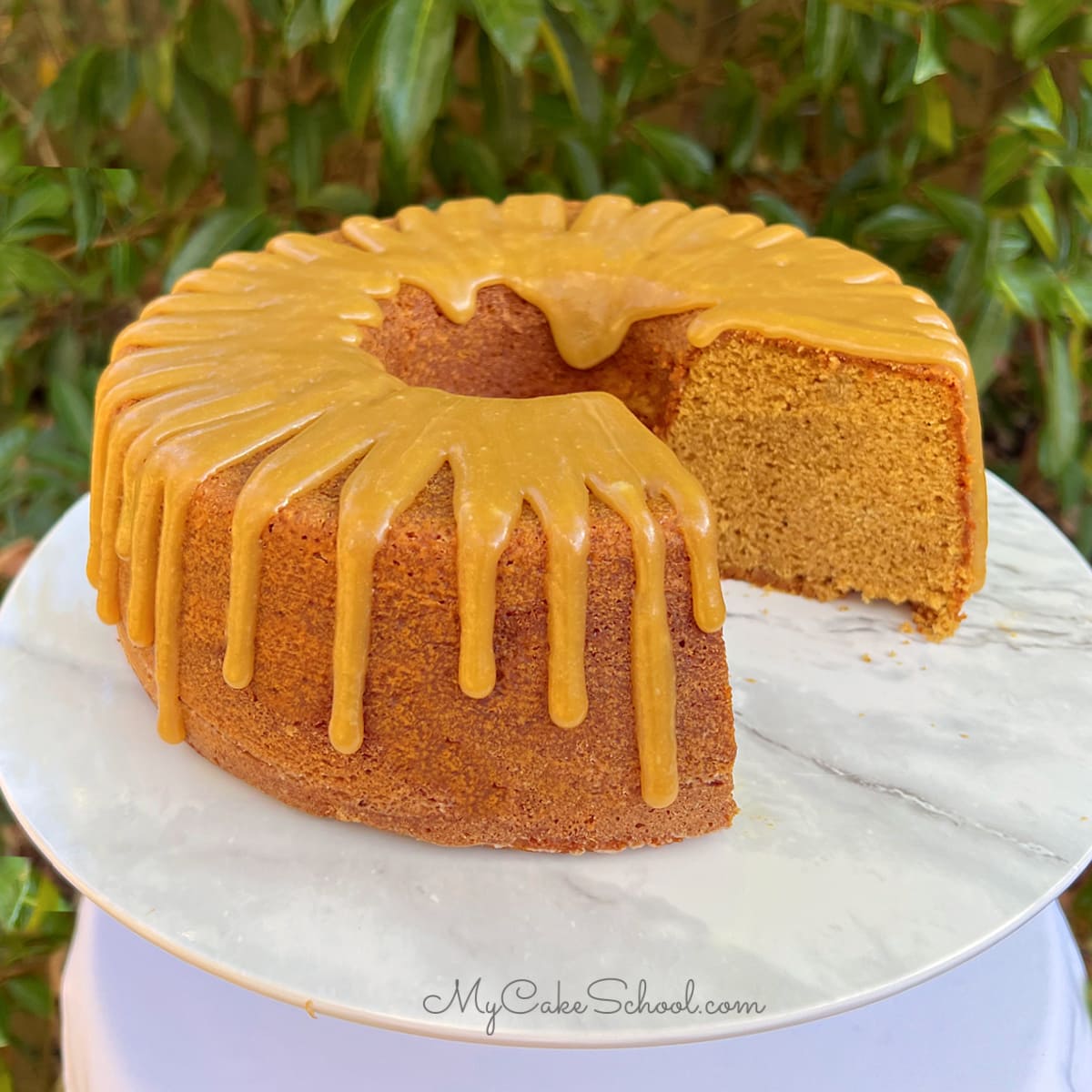 Gingerbread bundt cake, sliced, on a cake pedestal.