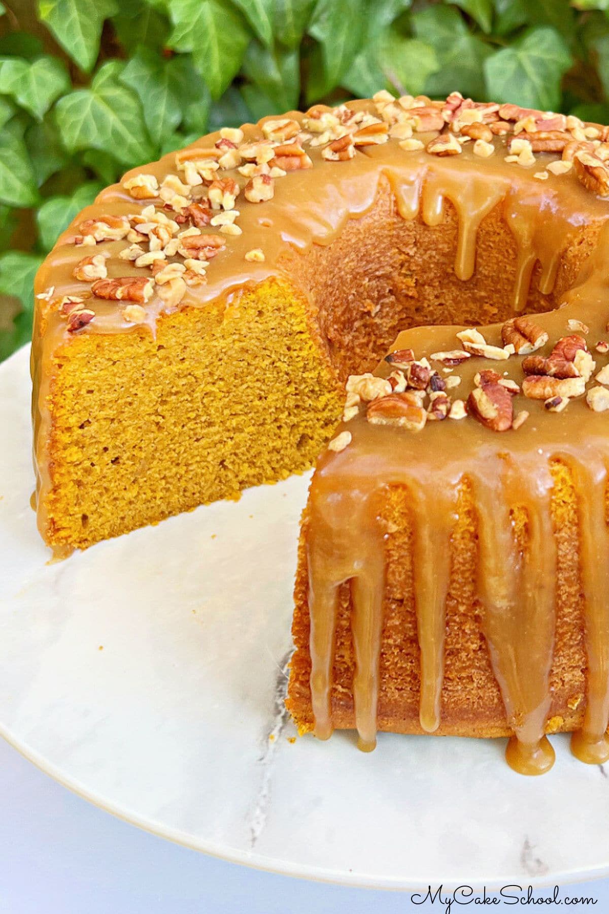 Sliced Pumpkin Bundt Cake on a cake pedestal.