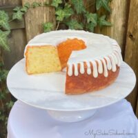 Pineapple Pound Cake, sliced, on a pedestal.