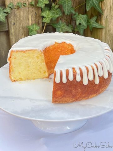 Pineapple Pound Cake, sliced, on a pedestal.