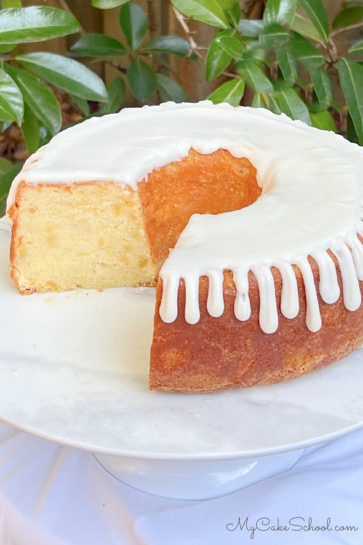 Sliced Pineapple Pound Cake on a cake pedestal.