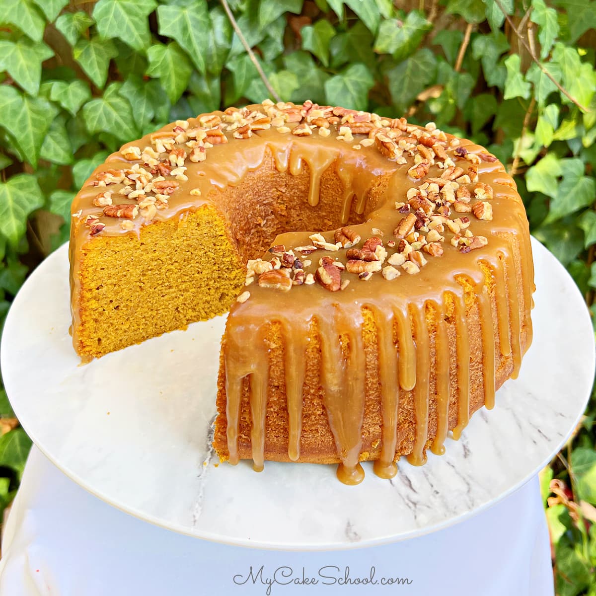 Sliced Pumpkin Bundt Cake on a cake pedestal.