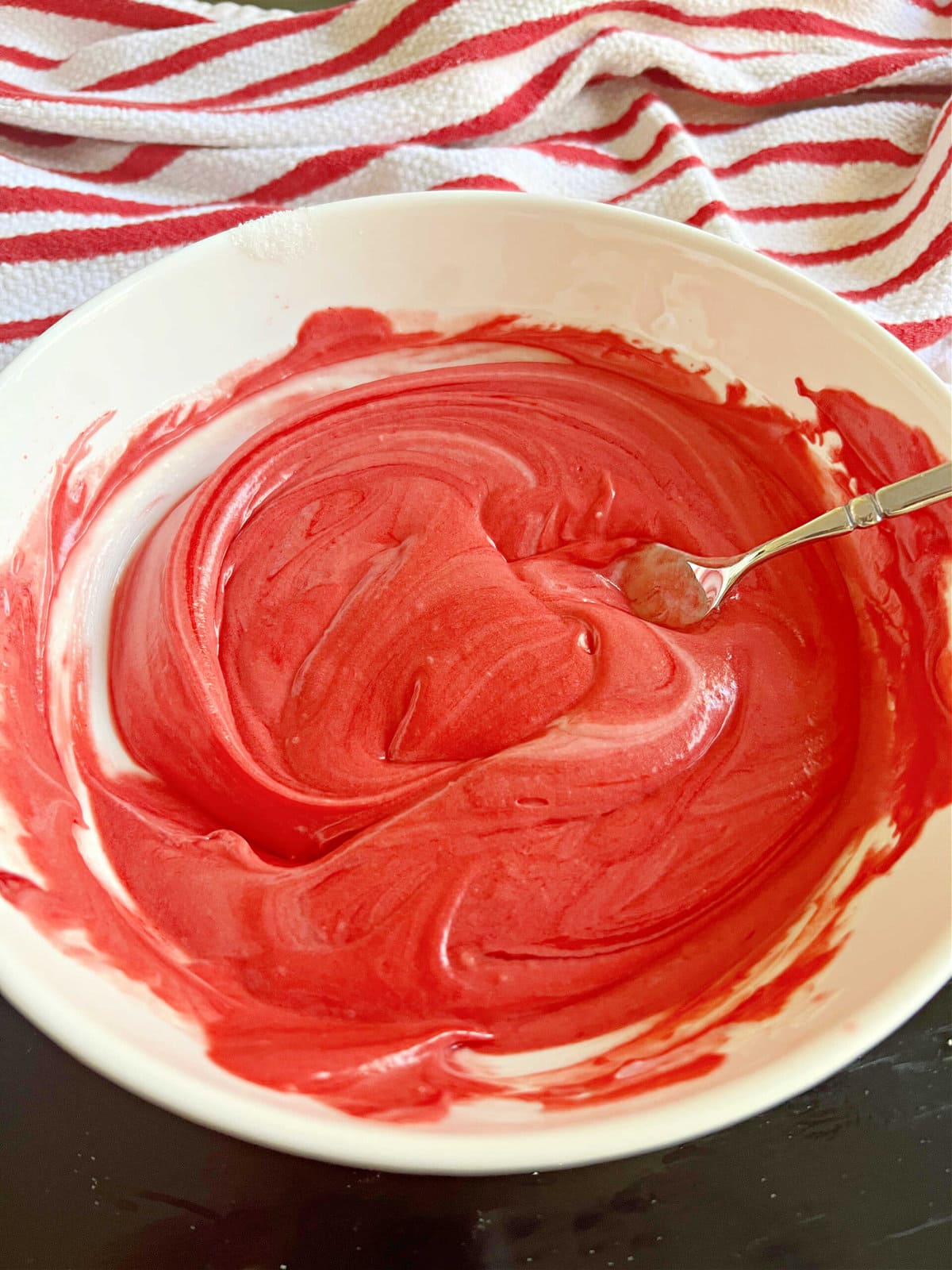 Reserved batter, tinted red in a small bowl.