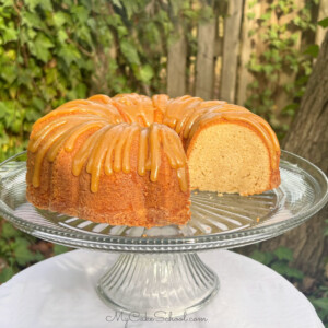 Sliced Caramel Eggnog Cake on a cake pedestal.