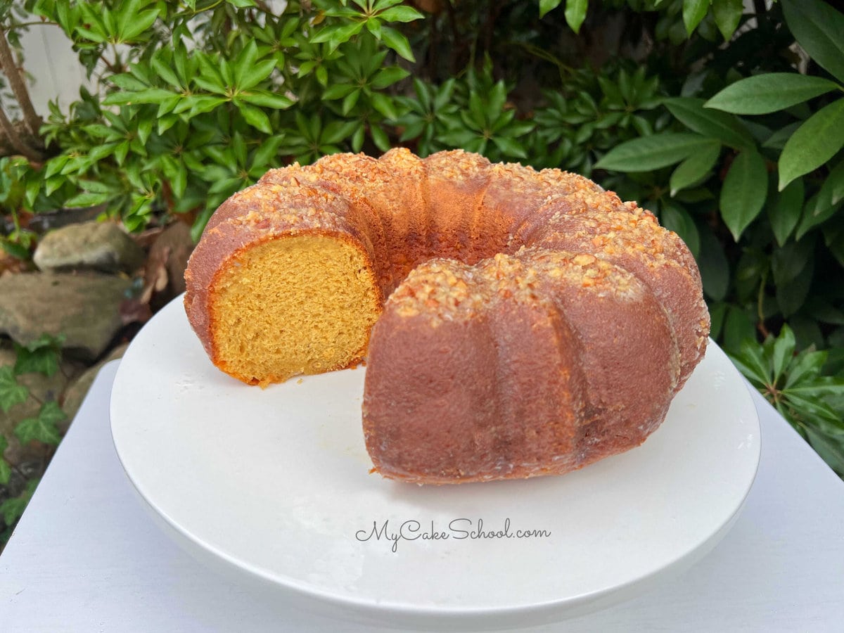 Eggnog Rum Cake, sliced, on a cake pedestal.