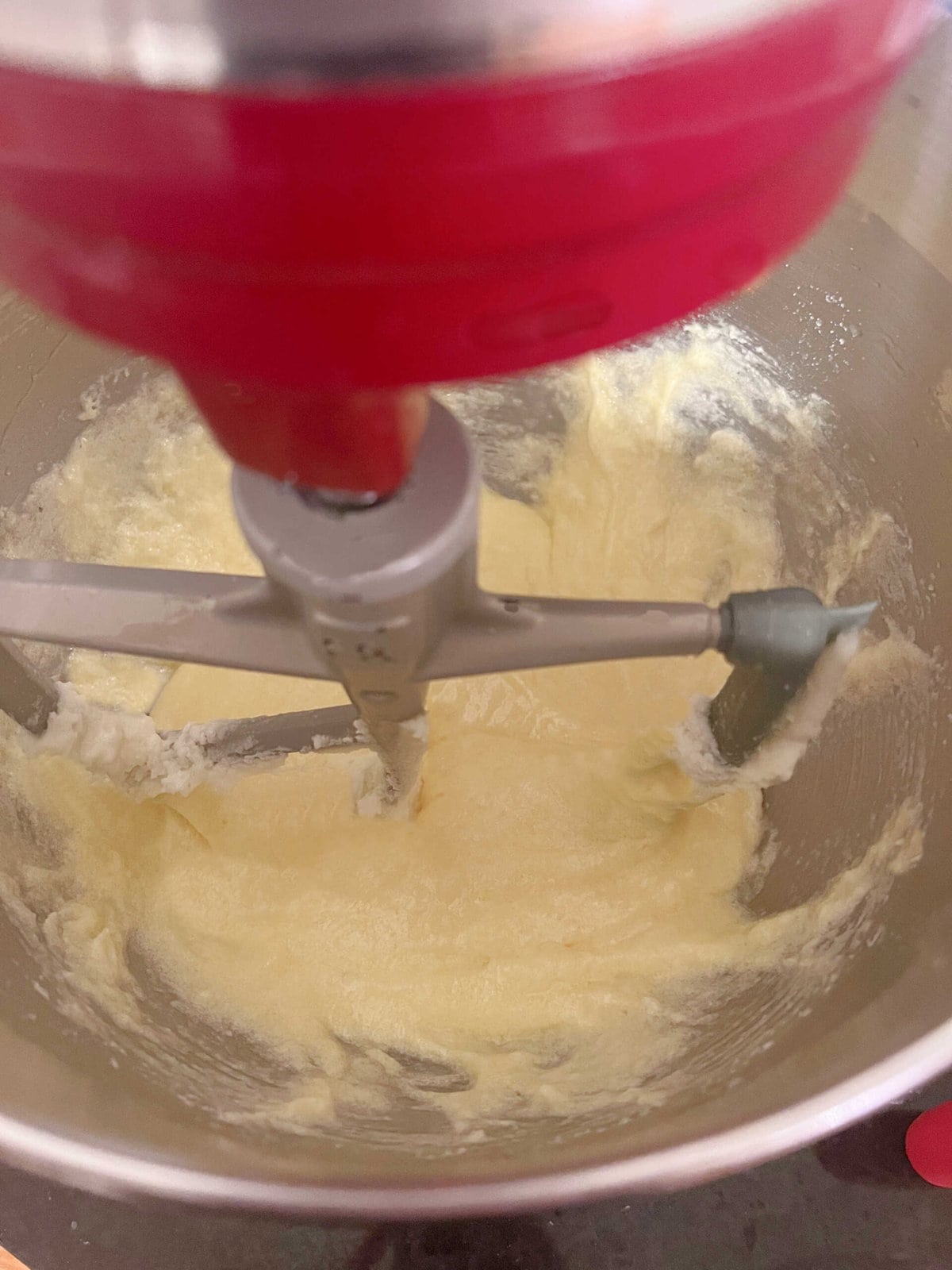 Adding eggs to cake batter.