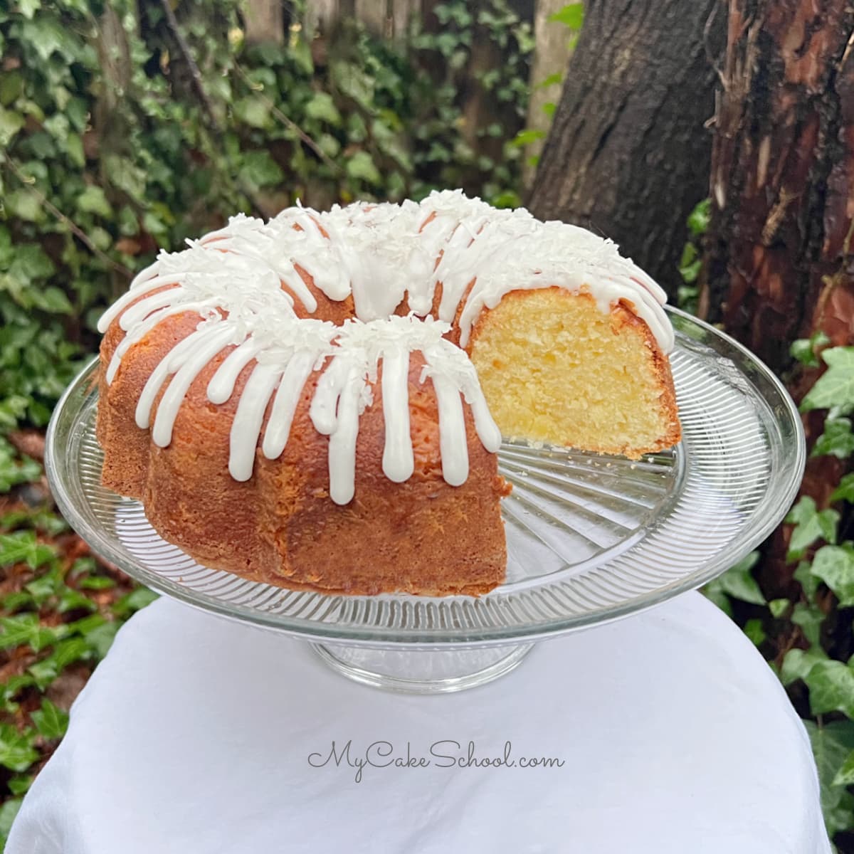 Sliced Pineapple Coconut Pound Cake on a pedestal.