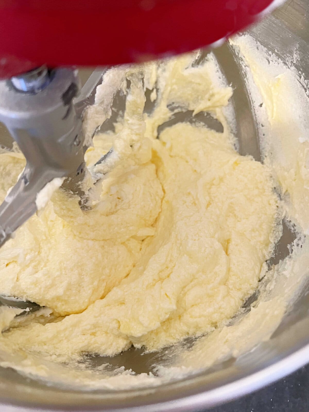 Adding eggs to butter and sugar mixture.