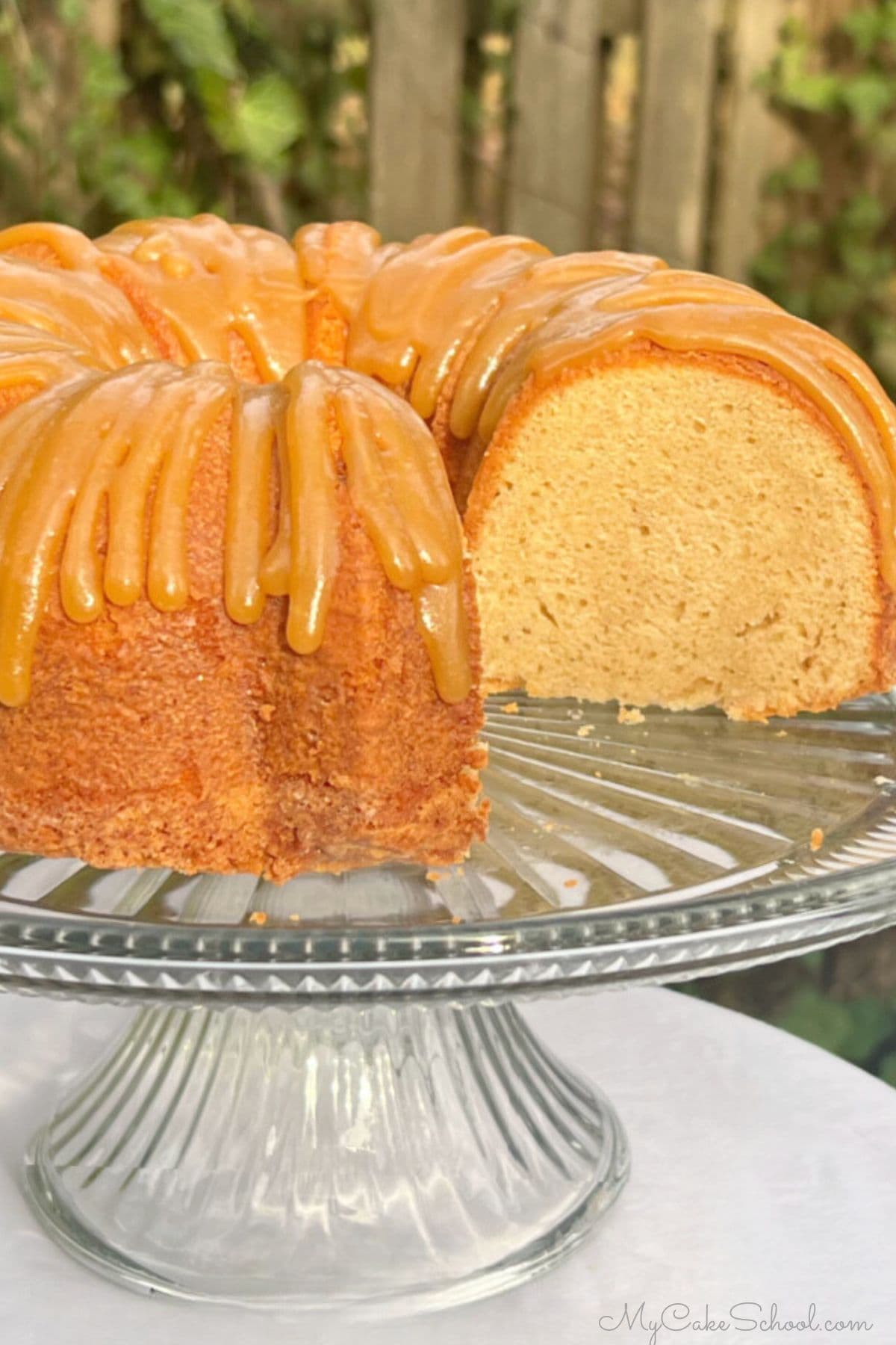 Caramel Eggnog Pound Cake, sliced, on a cake pedestal.