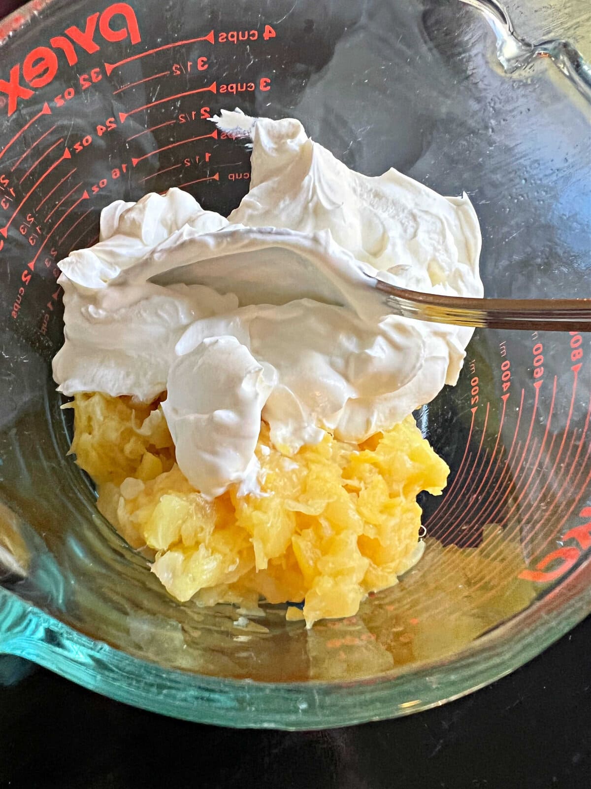 combining pineapple and sour cream.