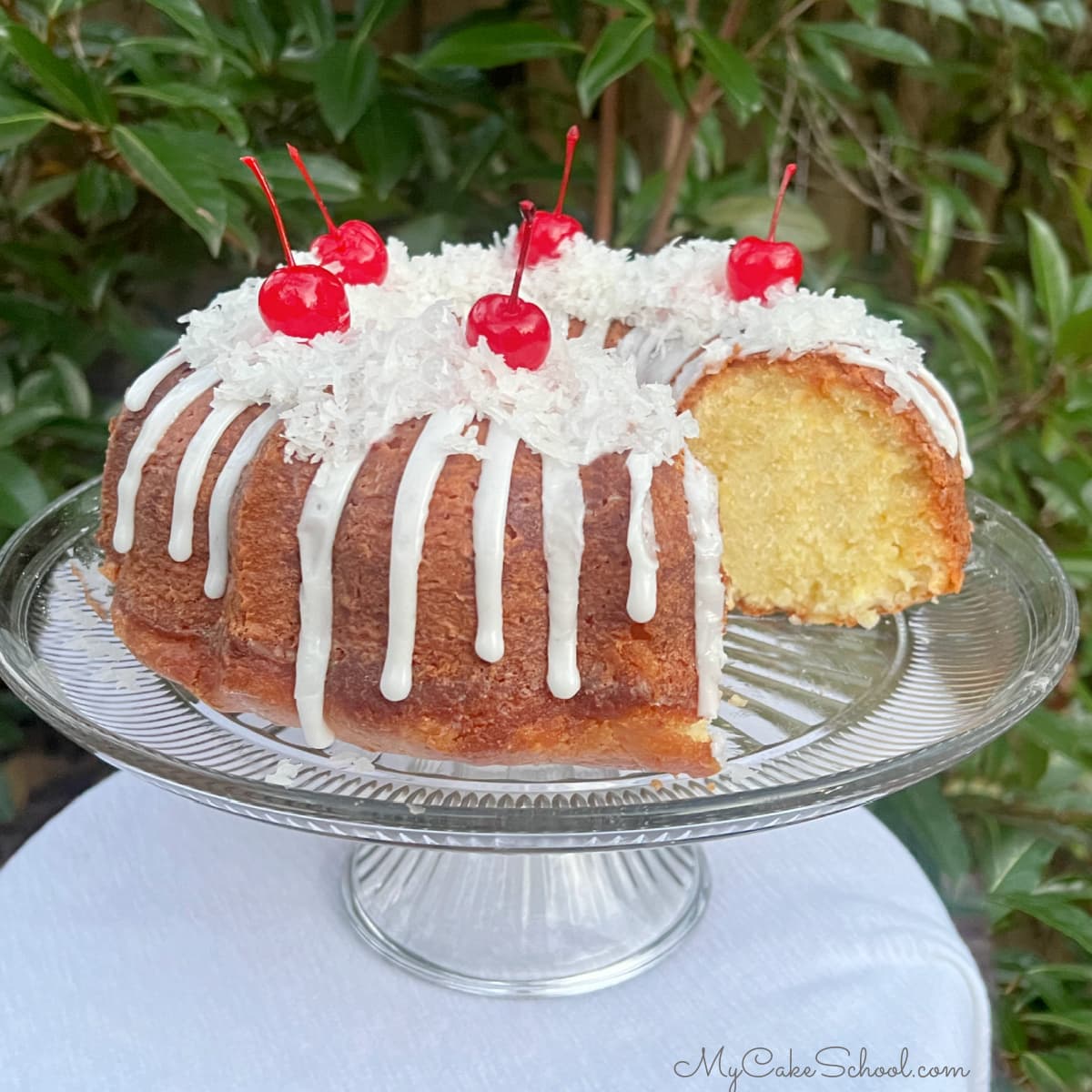 Sliced Pina Colada Pound Cake on pedestal.