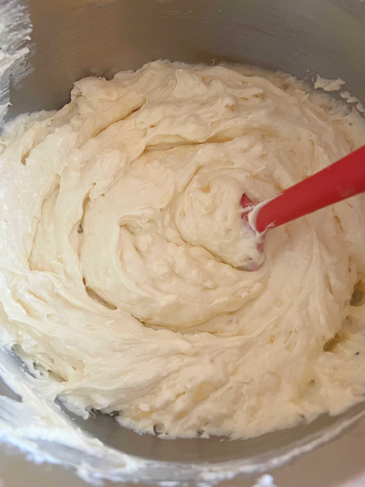Pineapple coconut cake batter in a mixing bowl.