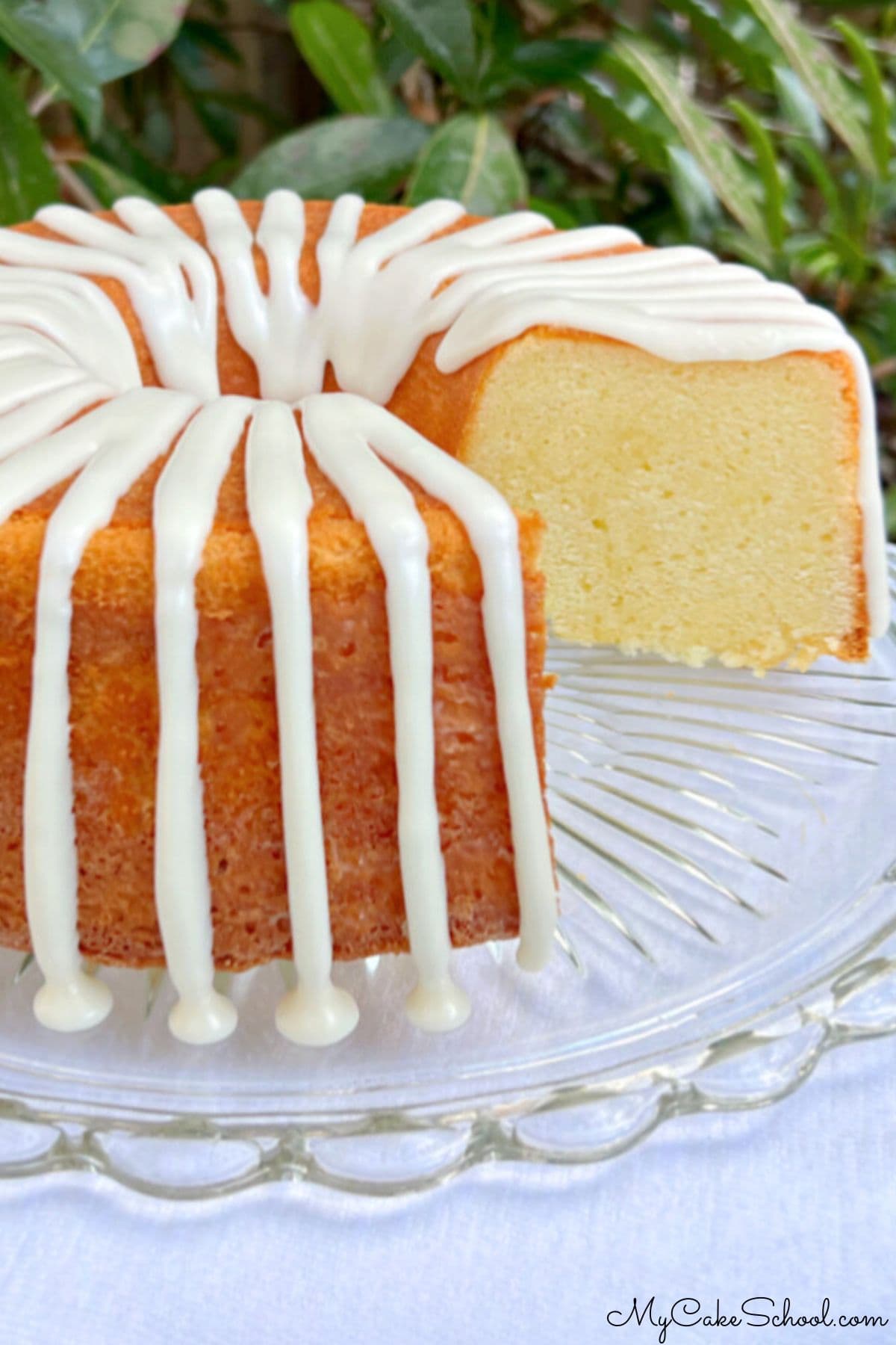 Five Flavor Pound Cake on a cake pedestal, sliced.