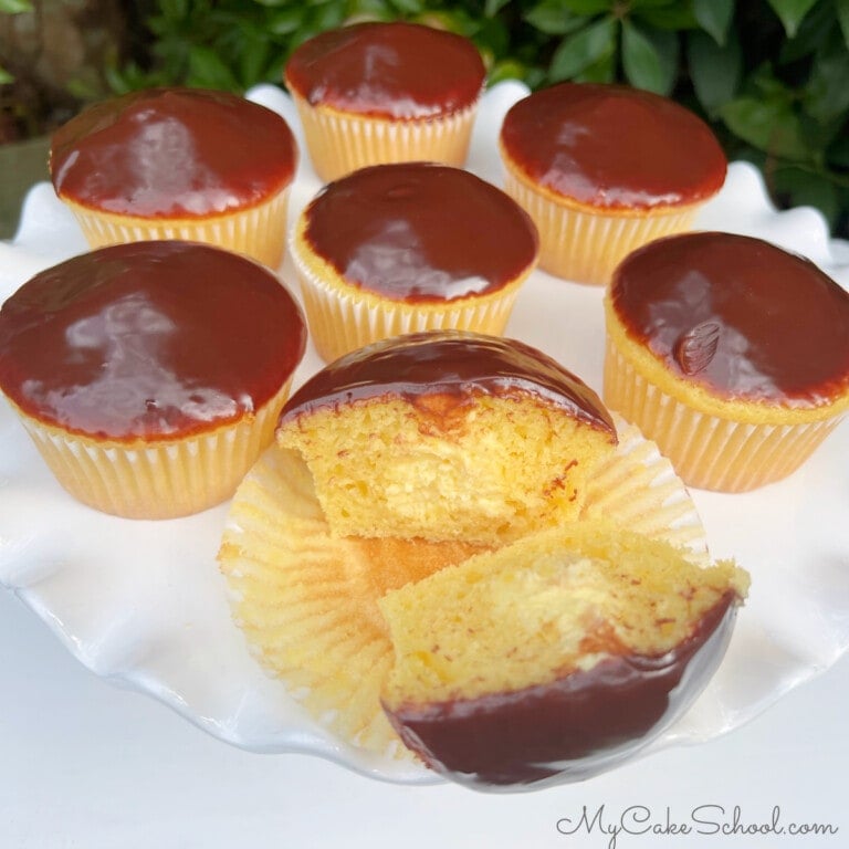 Boston Cream Cupcakes on a cake pedestal.