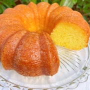 Sliced Limoncello Bundt Cake on a cake pedestal.