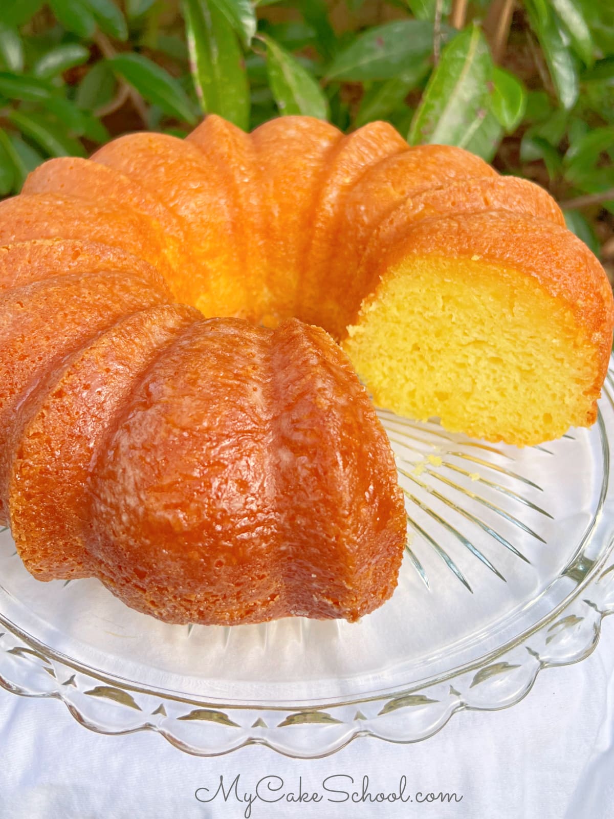 Sliced Limoncello Bundt Cake on a cake pedestal.