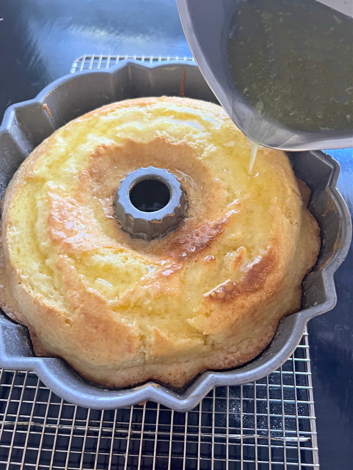 Pouring the Limoncello Glaze over the freshly baked cake, still in the pan.