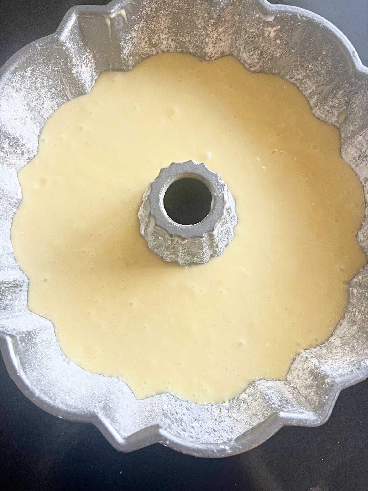 Prepared bundt pan filled with Limoncello Batter.