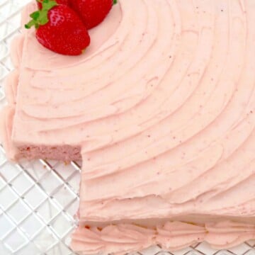 Strawberry Sheet Cake, sliced, on a cake platter.