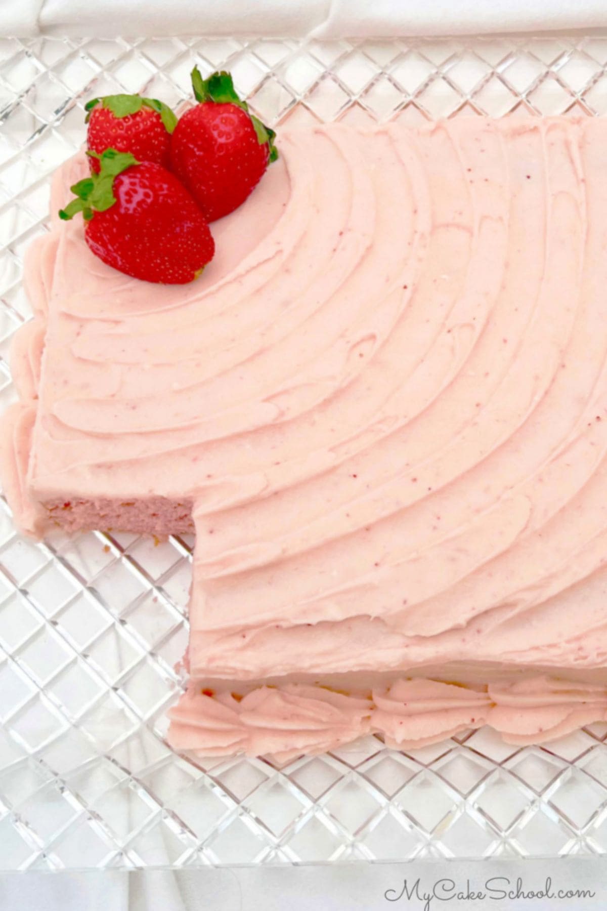 Strawberry Sheet Cake, sliced, on a cake platter.