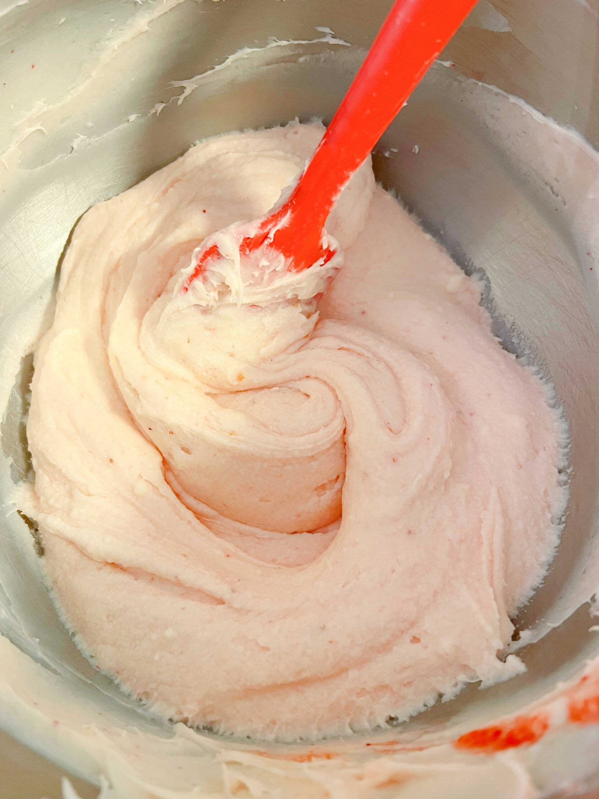 Strawberry cream cheese frosting in a mixing bowl.