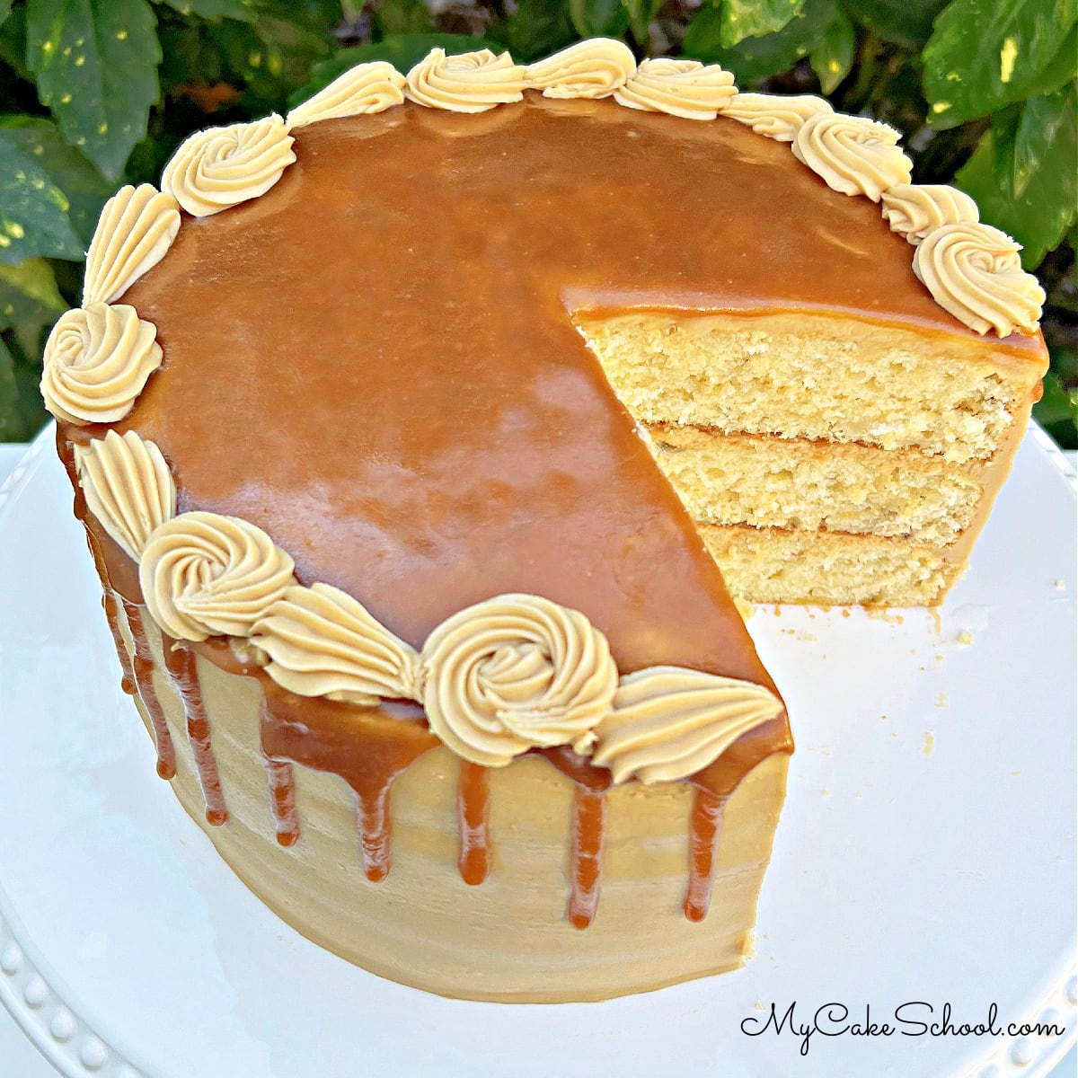 Caramel Banana Cake, sliced, on a pedestal.