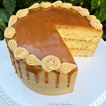 Banana Caramel Cake, sliced, on a cake pedestal.