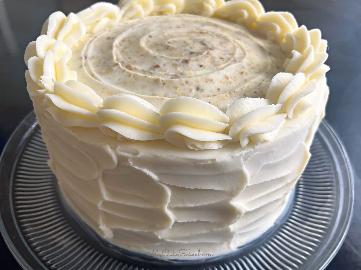 Frosted Pistachio Cake on table.